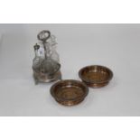 Silver plated cruet stand with 4 glass bottles and stoppers and 2 wine coasters