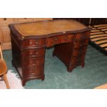 Reproduction kneehole desk with tooled leather writing surface and 9 drawers to one side,