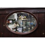 Oval bevelled edge wood framed mirror,