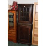 19th century oak glazed freestanding corner cupboard in two sections,