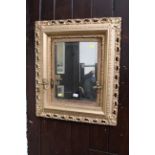 Gilt framed bevelled edge mirror with velvet border and mounted candle holders, 64 cm x 74 cm,