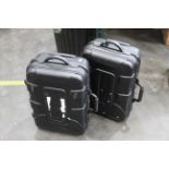 Two hard bodied combination lock suitcases