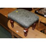 Stool with green upholstery