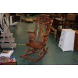 Carved wooden rocking chair with foot support