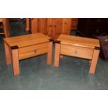 Pair of modern low tables each with two drawers to the front,