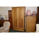 Modern oak wardrobe with drawer space below,