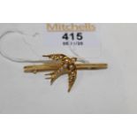 Gold coloured swallow brooch,