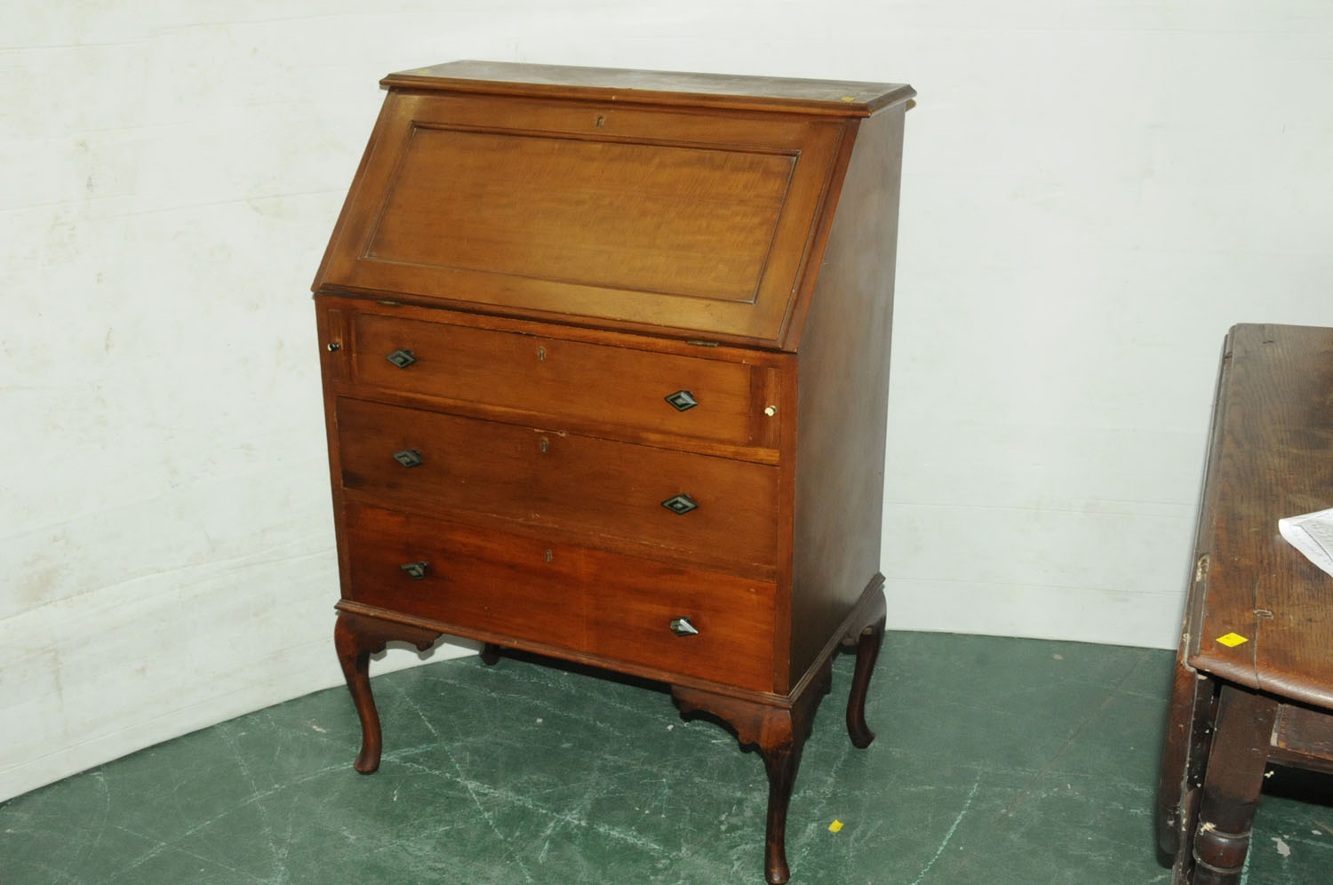 Mahogany bureau opening to a fitted interior with maroon tooled leather insert and drawers