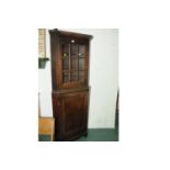 Oak freestanding corner cupboard with 9 panelled glazed door to top and cupboard door to bottom
