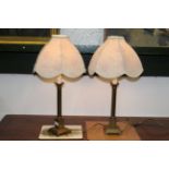 Two brass table lamps with cream and purple floral shades,