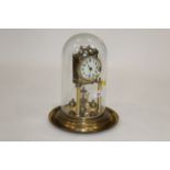 Perpetual motion brass mantle clock with glass dome,