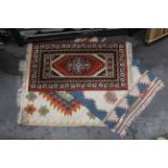 Three rugs to include orange patterned runner