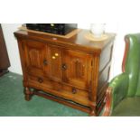 Priory style oak unit with carved front, pair of cupboard doors,