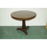 Mahogany circular centre table raised on a central column with triform base