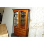 Modern china display unit with pair of glazed doors opening to mirrored back and 3 glass shelves