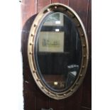 Oval gilt framed and bevelled mirror,