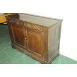Oak 2 door cupboard with plate rack above and carved frieze dated 1714