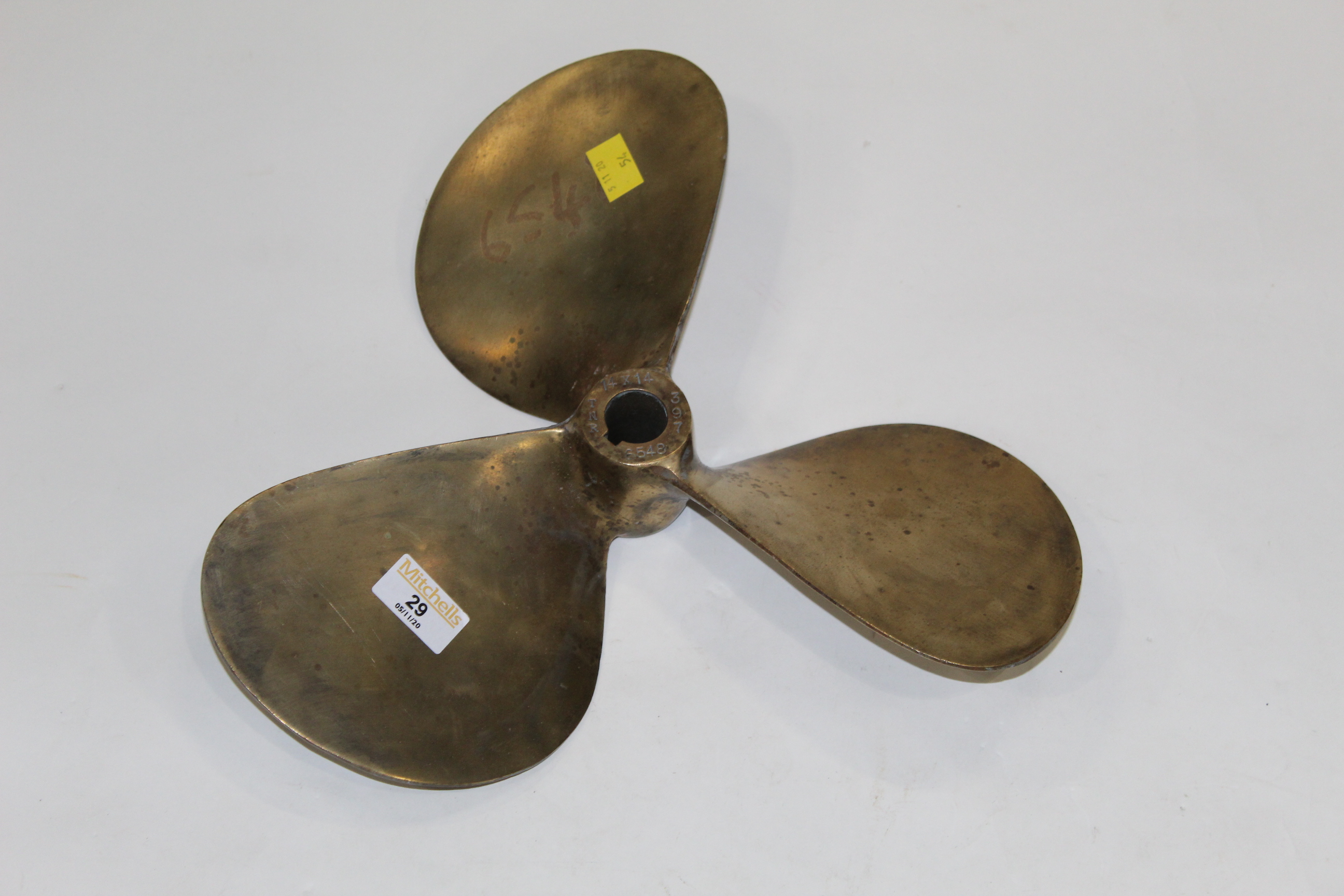 Vintage brass propeller marked to the centre TNR,