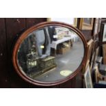 Oval mahogany framed and bevelled mirror,