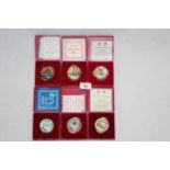 A group of six Halcyon Days Bilston enamel Christmas design boxes,