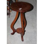A modern mahogany circular occasional table with triple baluster supports,