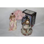 A modern plastic musical carrousel, 30 cm high, a plastic doll holding and parasol,