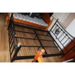 A modern black painted metal double bed in the 19th century style with metal coloured finials,