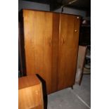 A mid century teak double wardrobe by Wrighton, 122 cm wide x 55 cm deep x 85 cm high.