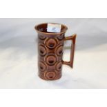 A Portmeirion "Jupiter" brown glazed pottery tall cylindrical mug with flared rim,