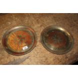 A pair of Near Eastern red and black enamelled engraved brass circular dishes,