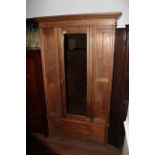 An Edwardian single mirror door wardrobe,