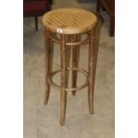 A vintage mid century bentwood and cane seated stool,
