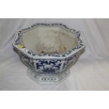 A 20th century octagonal blue and white jardiniere of Chinese design with pierced base and foliate