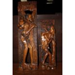 Two African hardwood relief carvings of huntsman, 53 & 74 cm high respectively.