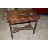 A Victorian pine side table fitted to drawers on turned legs with low under tier,