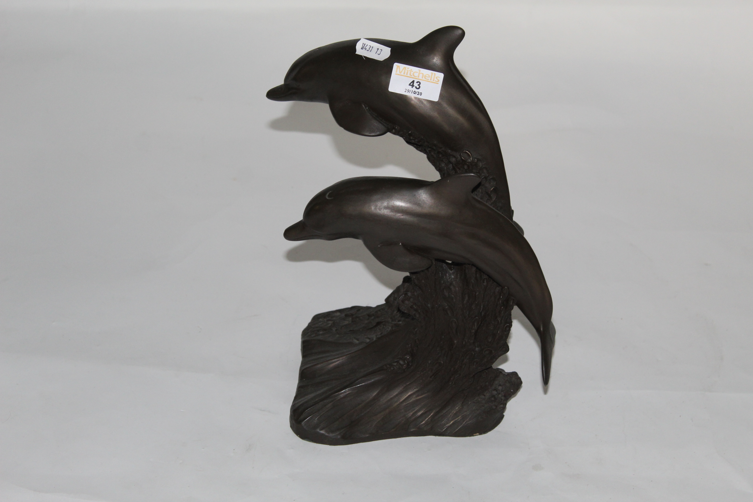 An Heredities bronzed resin figure of two leaping dolphins, 30 cm high.