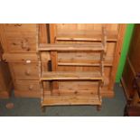 A small pine wall hanging plate rack with 3 shelves between shaped ends. 92 cm x 60 cm x 14 cm.