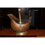 A copper & brass coal receiver of helmet form with brass over handle, 36 cm x 39 cm.