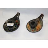 A pair of early 20th century Art Nouveau brown patinated copper and enamelled oval chamber sticks,