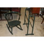 A mid century green painted spindle back rocking chair with tub form back and arms and slightly