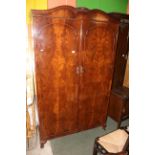 A 1940's figured mahogany three piece bedroom suite - 2 wardrobes and dressing table with triple