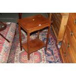 An Edwardian mahogany occasional table with moulded rectangular top above a shaped frieze and in