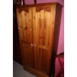 A pine wardrobe with fitted single drawer, 90 x 57 x 184 cm high.