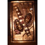 An African lacquered and embossed rectangular wall plaque,