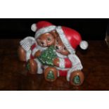 A slip cast pottery figure of two Chrismassy teddies. 15 cm high.