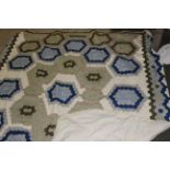A modern machine stitched patchwork coverlet,