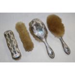 An early 20th century embossed silver backed brush set, 5 pieces, comprising a hand mirror,