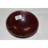A brown treacle glazed studio pottery low footed bowl, 16 cm diameter x 6 cm high,
