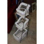 A modern metal framed woven wicker and painted wood kitchen storage unit with three divisions.