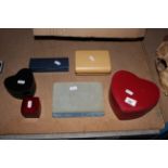 A red leather covered heart shaped slide action jewellery box and six other jewellery boxes.
